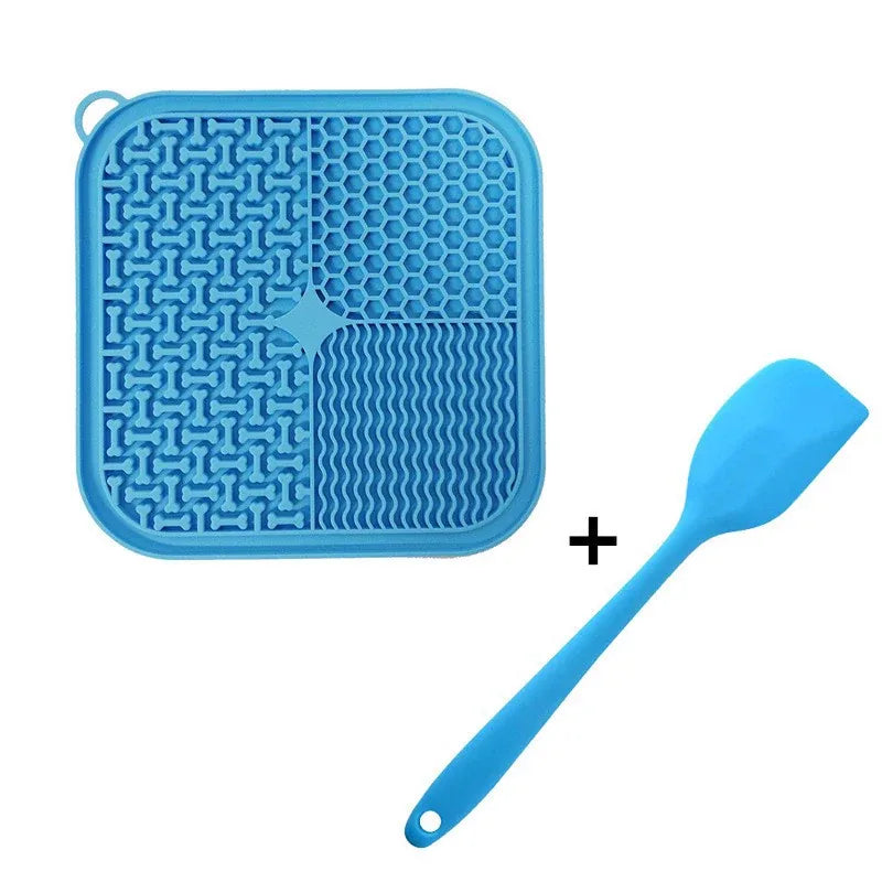 Blue silicone cat lick mat with four lick textures and matching spatula, isolated on white
