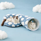 Cloud cat tunnel bed opened into an S shape — one cat napping on the cushion, another inside the tunnel