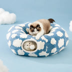 Cloud donut cat tunnel bed in sky blue with white tufted clouds, pom-pom hanging in the tunnel opening