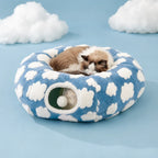 Cat sleeping curled on top of the assembled cloud donut tunnel bed