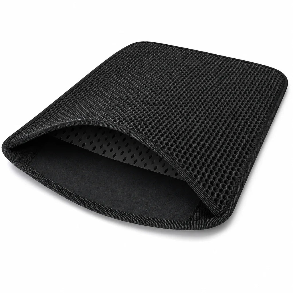Flexible black double-layer litter mat folded to show both layers