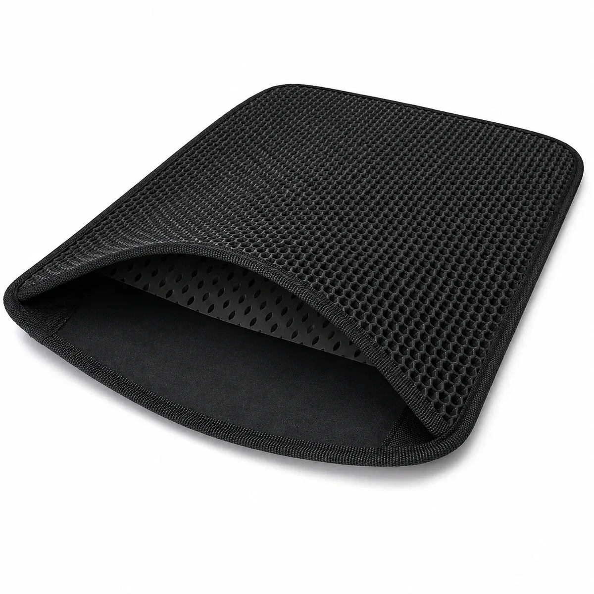 Flexible black double-layer litter mat folded to show both layers