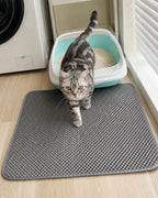 Grey litter mat placed in a laundry area