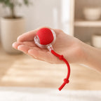 Motorized cat ball held in a hand showing its compact size