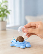 Removing the dust cap of the spinning catnip ball