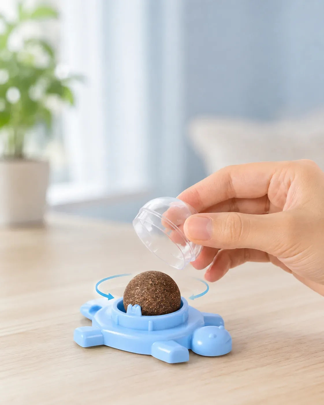 Removing the dust cap of the spinning catnip ball