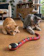 Two cats crouching to hunt the S-slithering smart snake cat toy on the floor