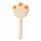 Steam grooming brush for cats in beige, isolated