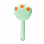 Steam grooming brush for cats in green, isolated