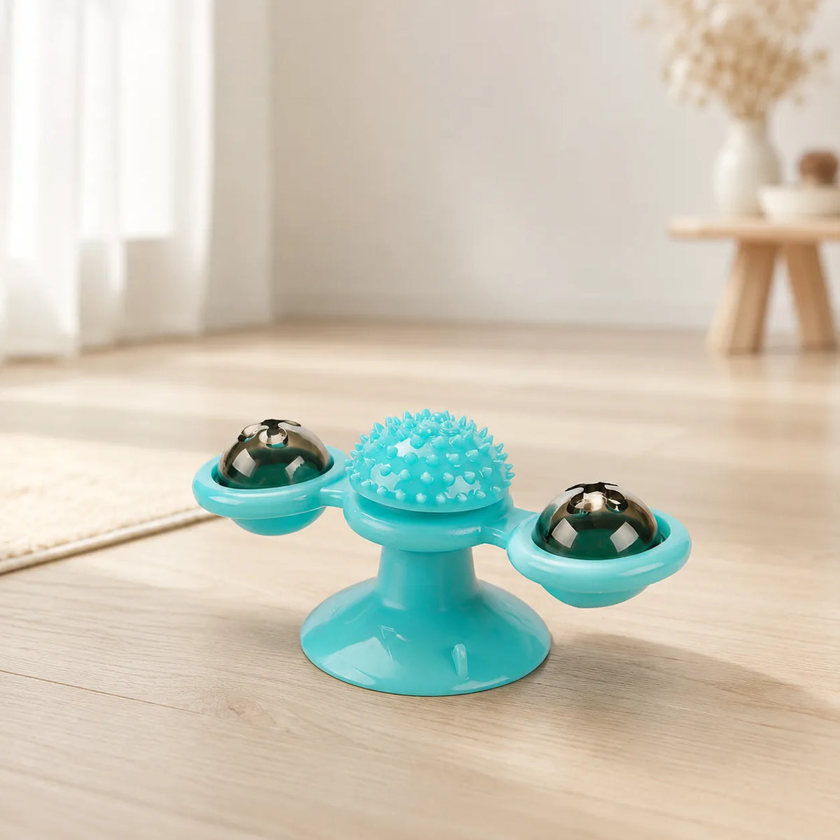 Teal windmill cat toy with suction cup base, spiky dental brush center and two spinning treat balls